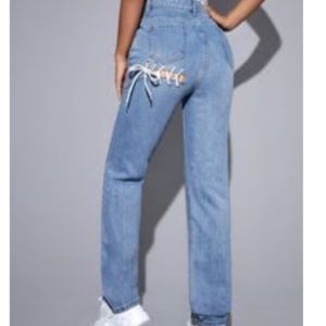 Plain boot cut jeans with a ripped and tights laced in the back of the pants